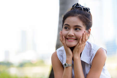 Happy young beautiful Asian woman at the park outdoorsの写真素材
