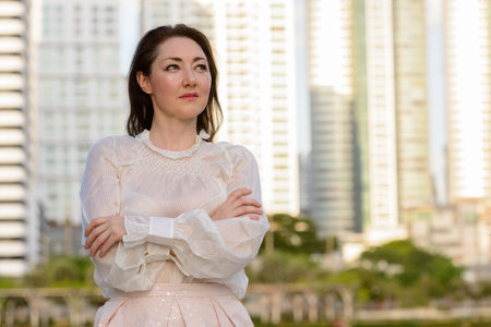 Mature beautiful businesswoman at the park in the city