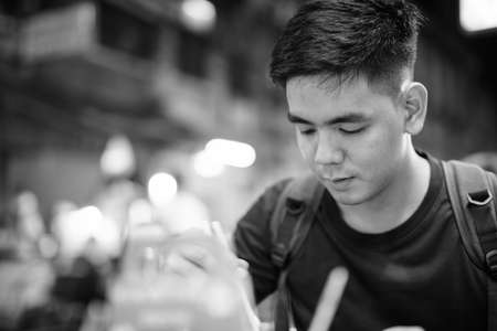 Portrait of young handsome Asian tourist man exploring at Chinatownの写真素材