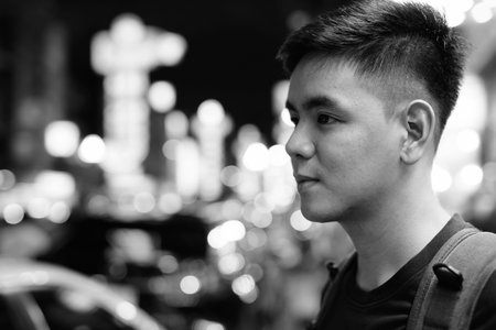 Portrait of young handsome Asian tourist man exploring at Chinatown