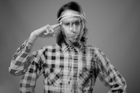 Studio shot of rebellious young man against gray background