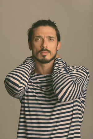 Studio shot of handsome man thinking while posing