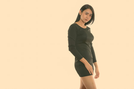 Studio shot of young Asian transgender woman standing