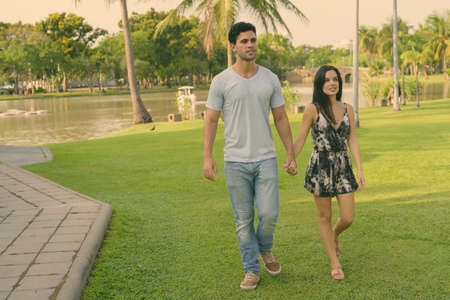 Young Hispanic couple relaxing in the park togetherの写真素材