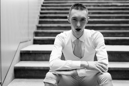 Young handsome androgynous businessman exploring around the city