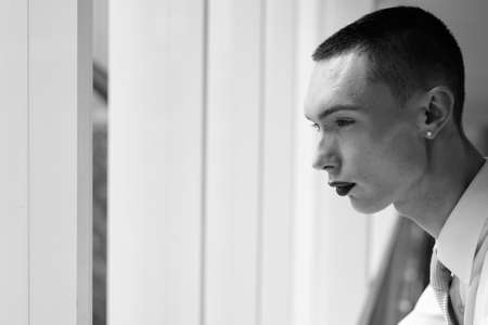 Young handsome androgynous businessman exploring around the cityの写真素材