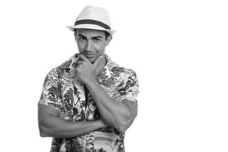Studio shot of young handsome Persian tourist man ready for vacation