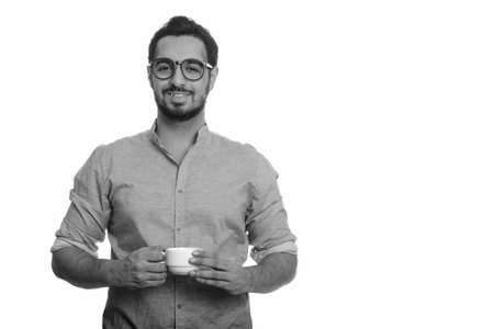 Young happy Indian man holding coffee cupの写真素材