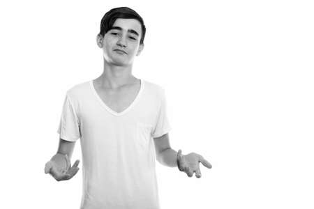 Studio shot of young handsome Persian teenage boy looking confusedの写真素材