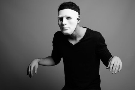 Portrait of young Persian man wearing white mask