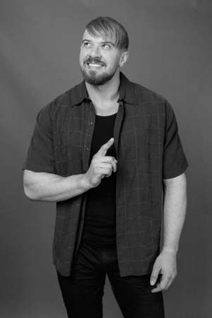 Bearded man with blond hair against gray backgroundの写真素材