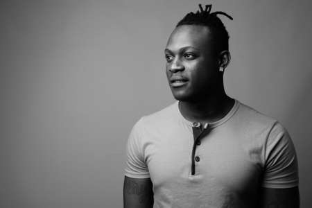 Young handsome African man from Kenya against gray backgroundの写真素材