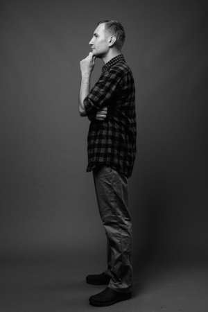 Portrait of hipster man against gray backgroundの写真素材