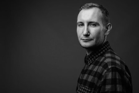Portrait of hipster man against gray background