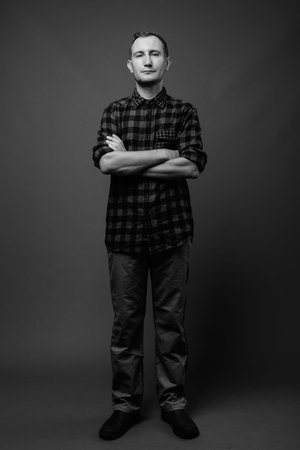 Portrait of hipster man against gray backgroundの写真素材
