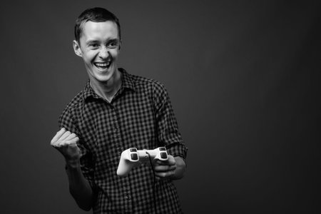 Portrait of young hipster man playing games
