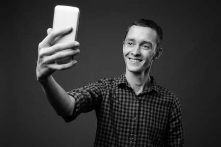 Portrait of young hipster man with phoneの写真素材