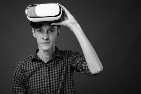 Portrait of young hipster man using VR glassesの写真素材