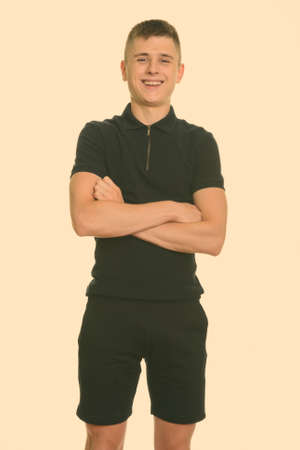 Young happy Caucasian man smiling with arms crossedの写真素材