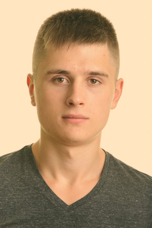 Face of young handsome man looking at camera