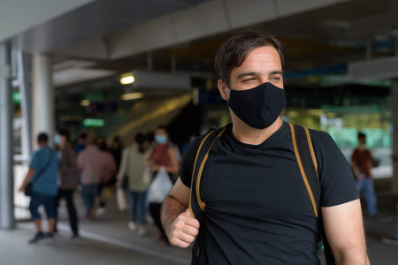 Portrait of Persian man with mask thinking at the sky train station
