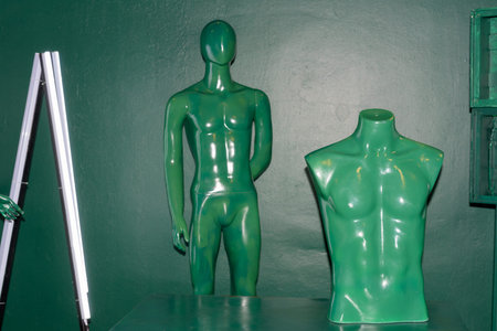 Green naked man mannequin inside green artistic studio room