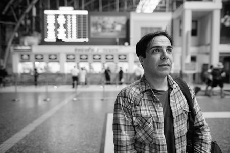 Portrait of handsome Persian tourist man at the railway station