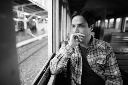 Portrait of handsome Persian tourist man at the railway stationの写真素材