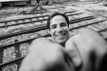 Portrait of handsome Persian tourist man at the railway station