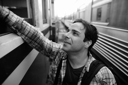 Portrait of handsome Persian tourist man at the railway station