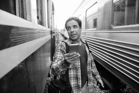 Portrait of handsome Persian tourist man at the railway station