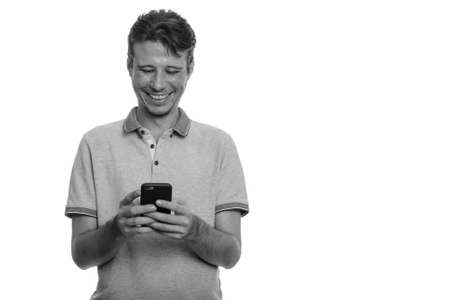Portrait of happy handsome man using phoneの写真素材
