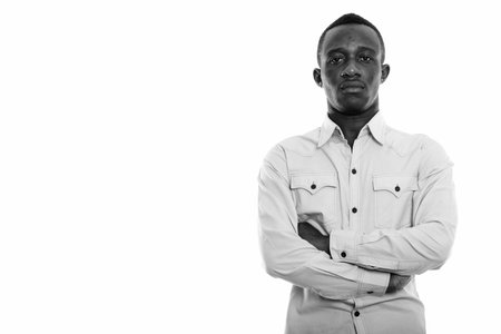 Studio shot of young black African man with arms crossed
