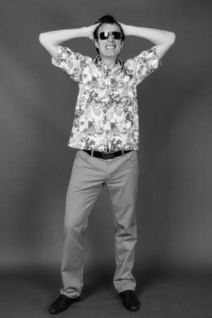 Mature handsome tourist man against gray backgroundの写真素材