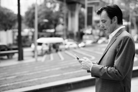 Mature handsome businessman exploring around the city