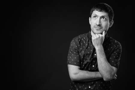 Portrait of Hispanic businessman against black backgroundの写真素材