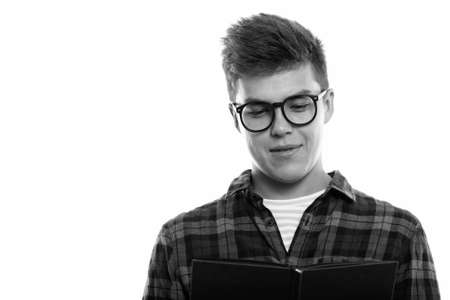 Close up of young handsome man reading bookの写真素材