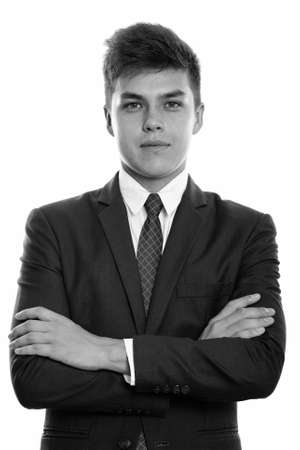 Studio shot of young handsome businessman with arms crossedの写真素材