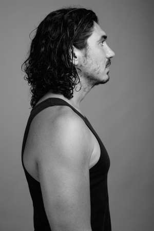 Handsome macho man with mustache against gray backgroundの写真素材