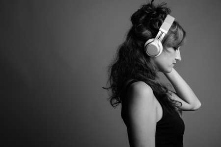 Profile view of beautiful woman listening to music with eyes closedの写真素材