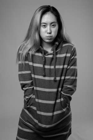 Portrait of young Asian woman wearing hoodieの写真素材