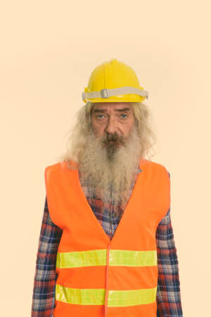 Studio shot of senior bearded man construction workerの写真素材