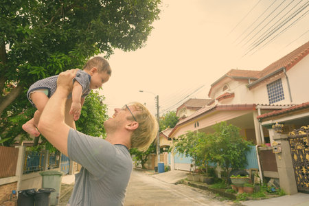Father and baby son bonding together at home outdoors