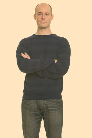 Portrait of handsome bald man with arms crossed