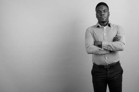 Portrait of young African businessman against white backgroundの写真素材