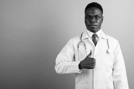 Young African man doctor against white backgroundの写真素材