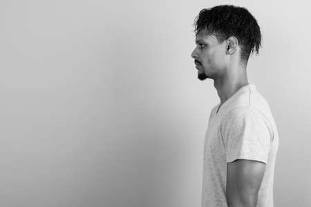 Young bearded handsome African man against gray backgroundの写真素材