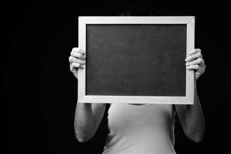 Mature beautiful woman with short hair against black backgroundの写真素材