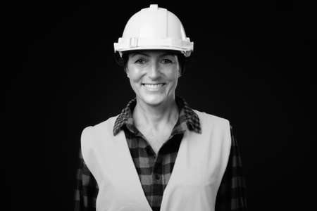 Happy mature beautiful woman construction worker with short hairの写真素材