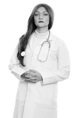 Studio shot of woman doctor standing with hands togetherの写真素材